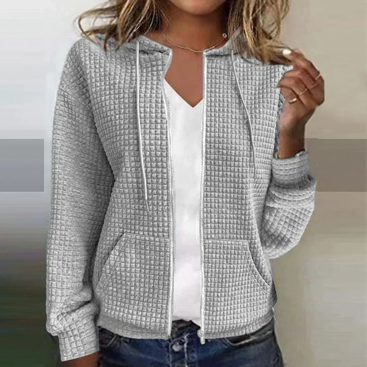 Soft women's cozy zip-up jacket in a neutral color, offering comfort & warmth for everyday casual outfits.