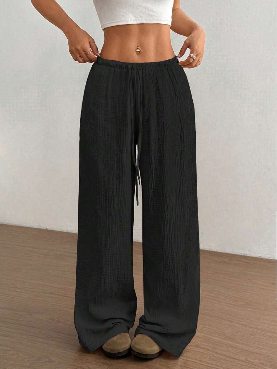 Bohemian relaxed fit women's wide leg crinkle pants, drawstring waist, ideal for summer comfort.