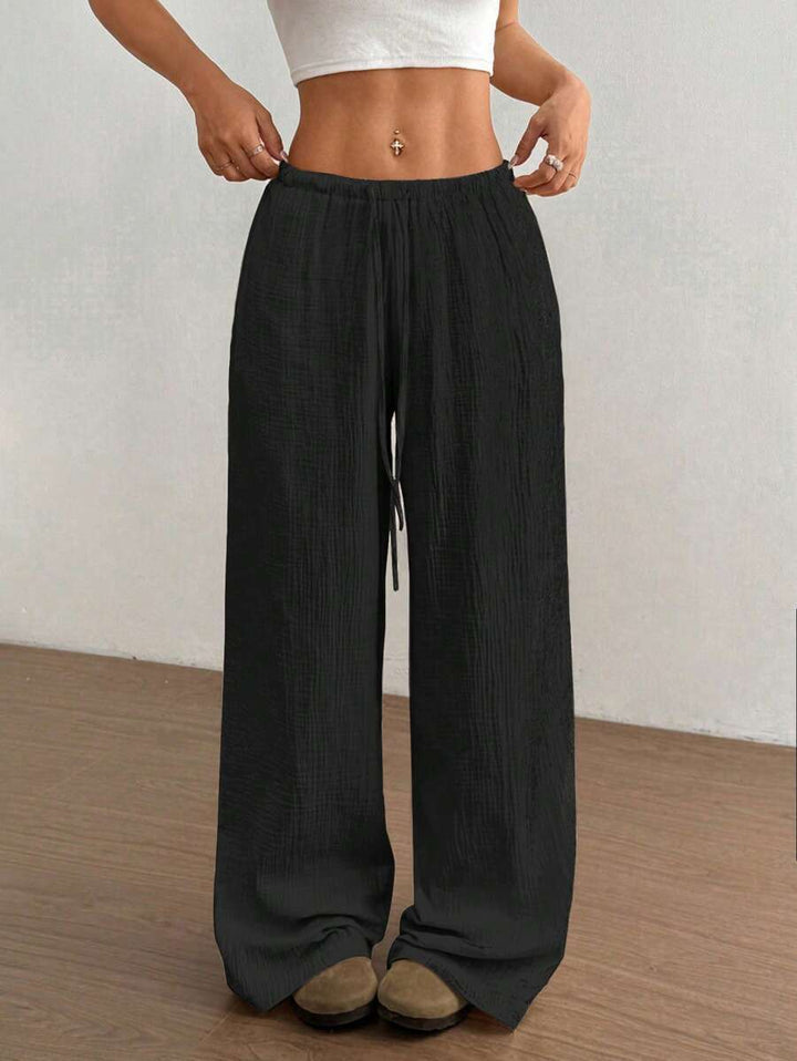 Bohemian relaxed fit women's wide leg crinkle pants, drawstring waist, ideal for summer comfort.