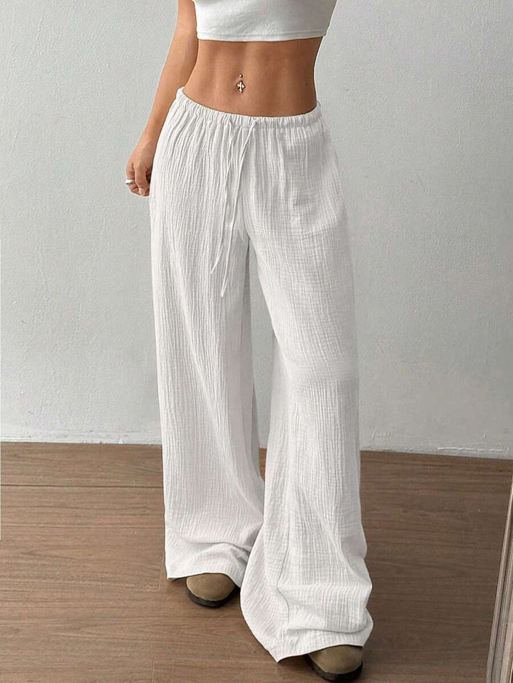 Detail shot: Women's crinkle texture wide leg pants, highlighting elastic drawstring waist & fabric.