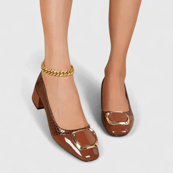 Close-up of a women's croc embossed loafer, showing the texture, block heel & gold buckle detail.