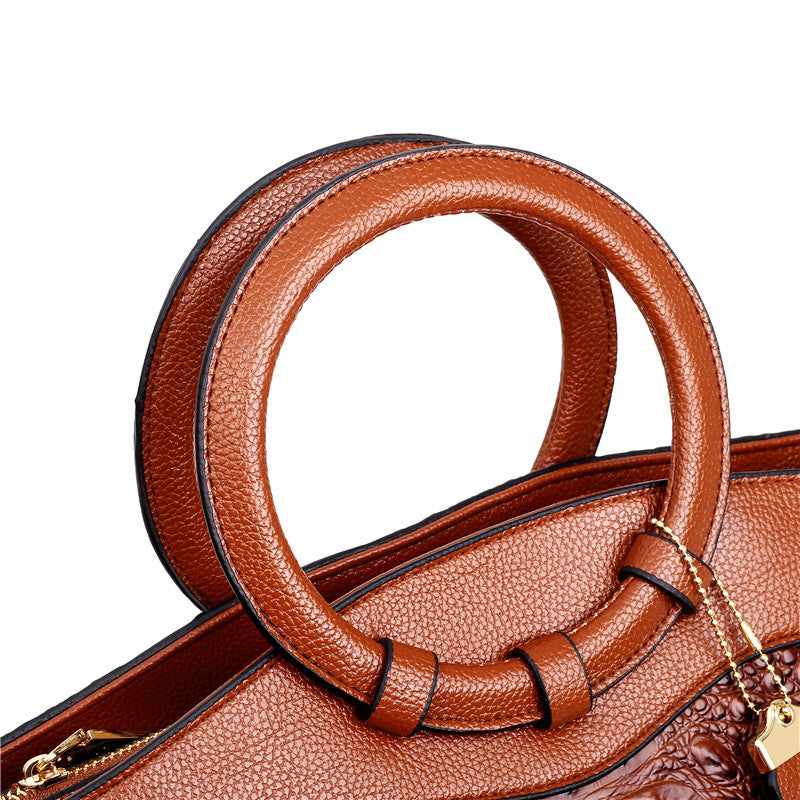 Fashionable women's handbag, vintage style with croc embossing & a unique round handle.