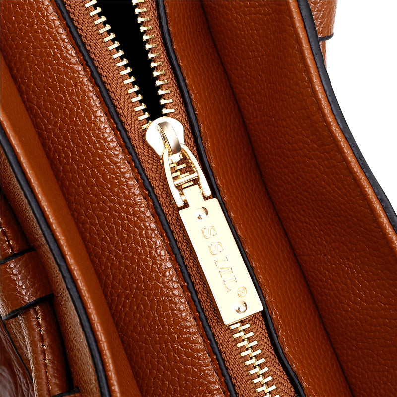 Classic women's faux leather croc embossed handbag with a chic round handle, vintage appeal.