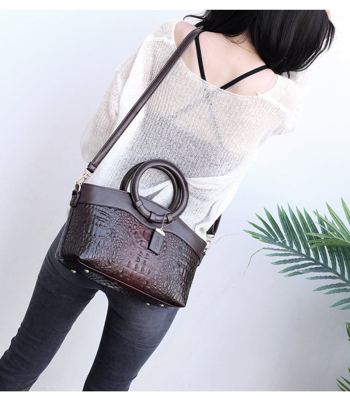 Perfect accessory: Women's vintage croc embossed handbag with an elegant round top handle.
