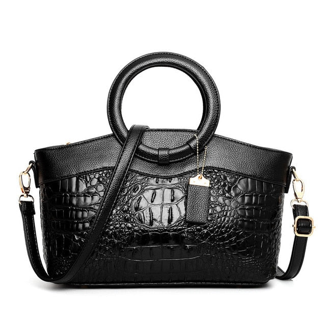 Chic women's faux leather handbag. Croc embossed, vintage design, with a unique round handle.