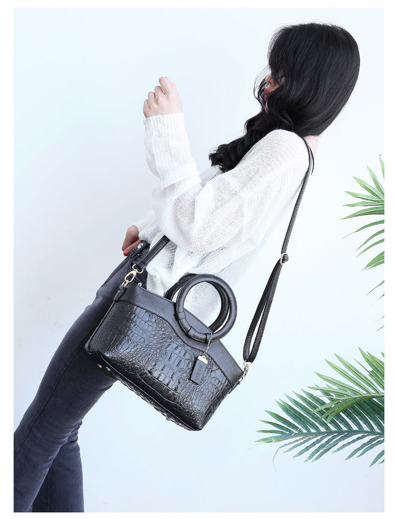 Statement women's handbag: vintage croc embossed style with a distinctive round handle.