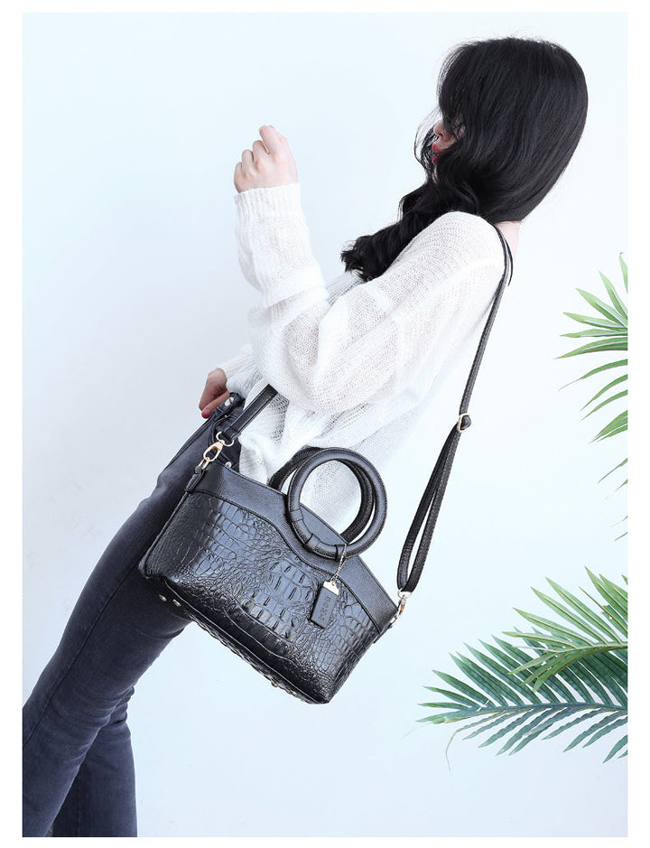 Statement women's handbag: vintage croc embossed style with a distinctive round handle.