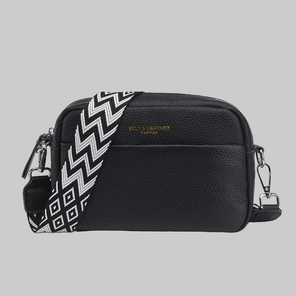 Women's crossbody bag with unique geometric strap. Stylish and versatile for everyday fashion.