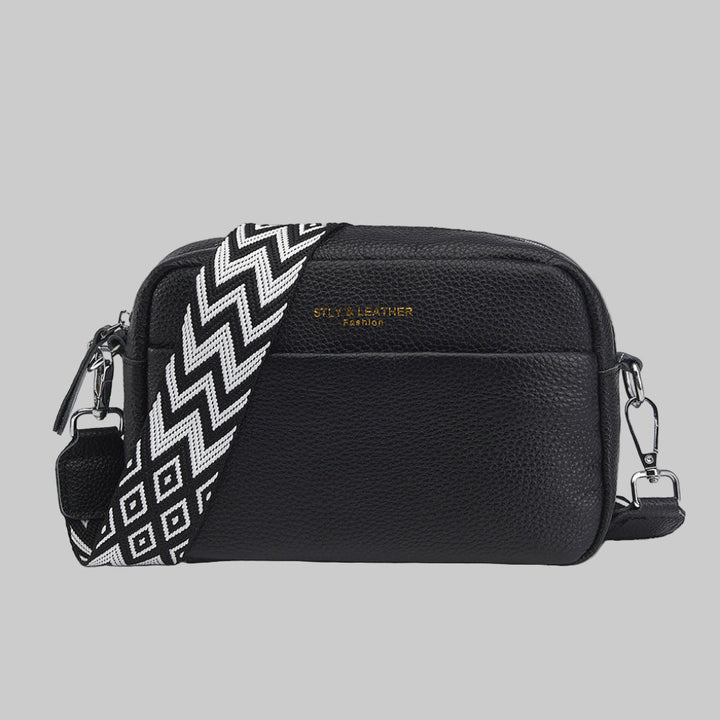 Women's crossbody bag with unique geometric strap. Stylish and versatile for everyday fashion.