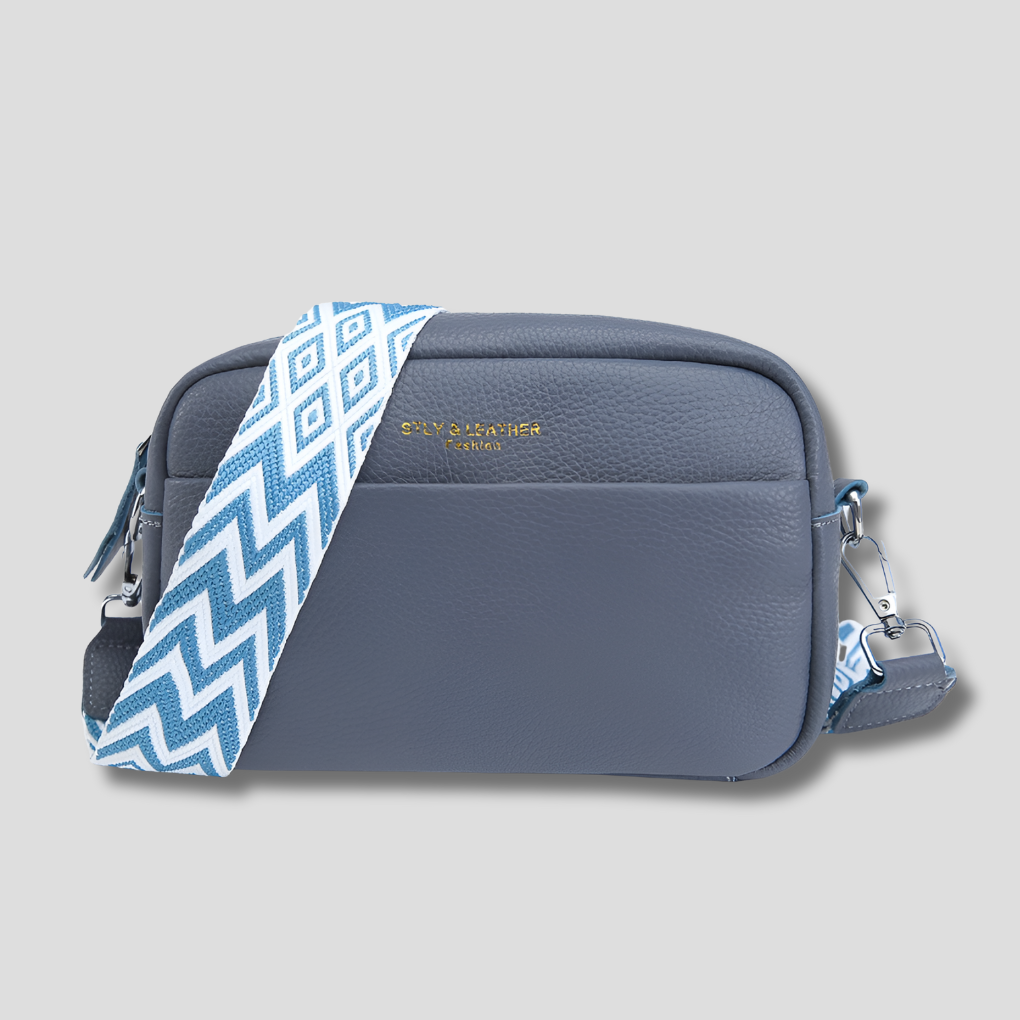 Elegant black women's crossbody bag. Features a trendy geometric strap, perfect as a fashion accessory.