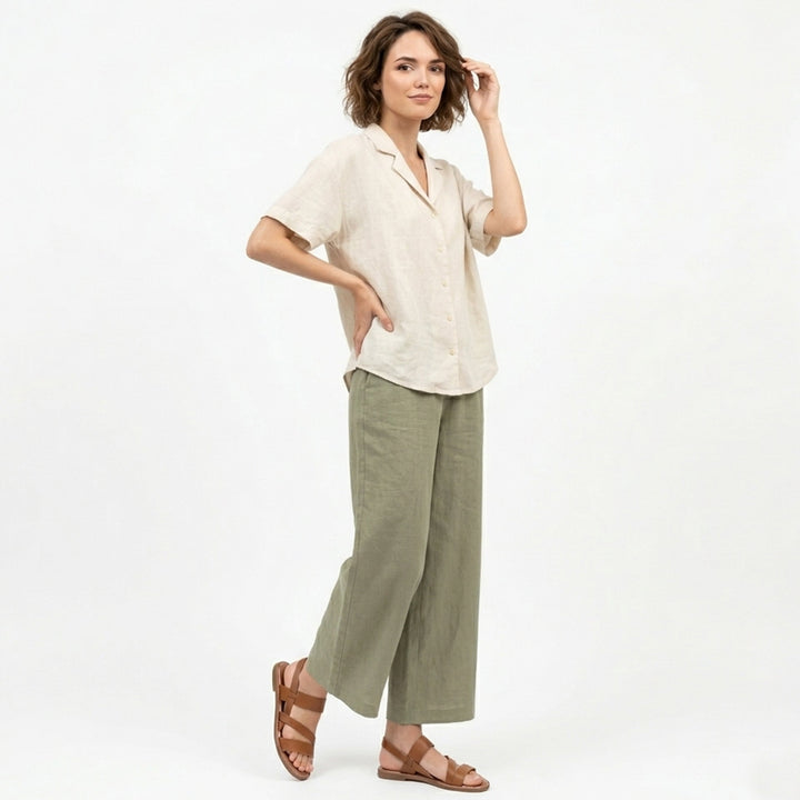 Casual women's slip-on flat sandals featuring a trendy crossover strap design.