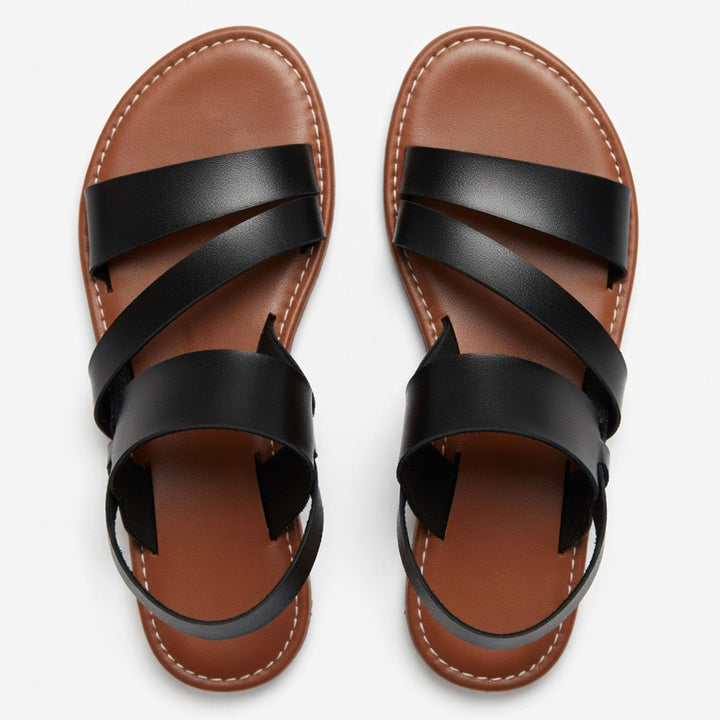 Women's comfortable flat sandals with crossover straps, great for beach & everyday use.