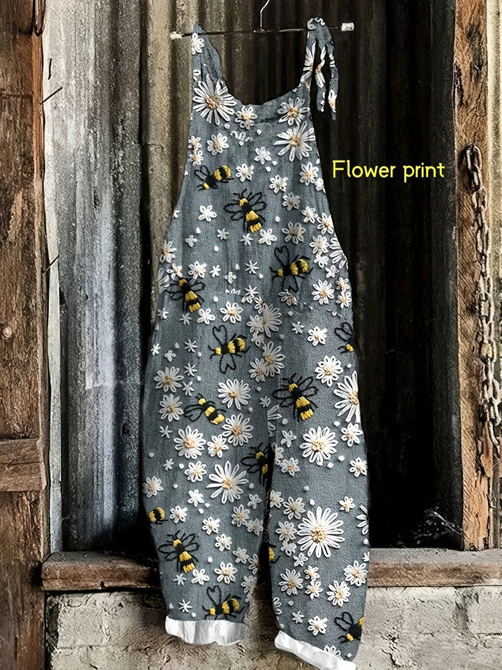 Bohemian style wide leg women's jumpsuit with adjustable tie shoulders and daisy bee pattern.