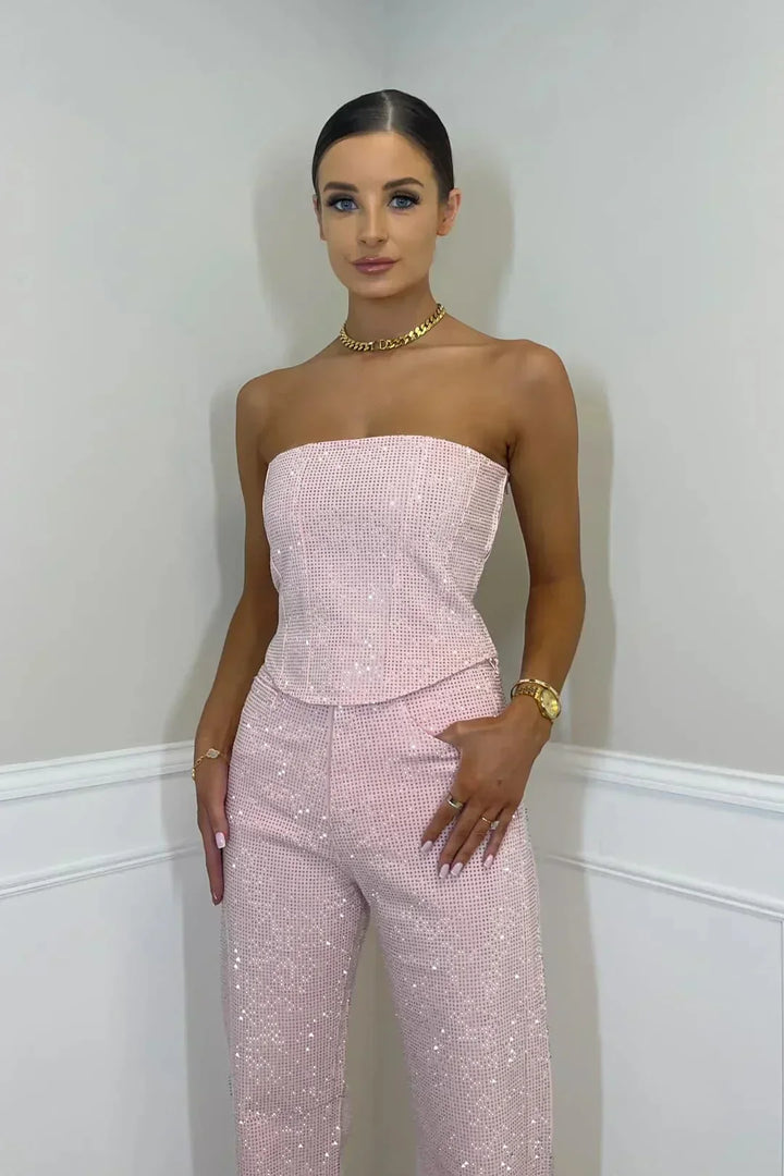 Shimmering women's glitter crop top, part of a high-waist jeans set. Perfect sparkling attire.