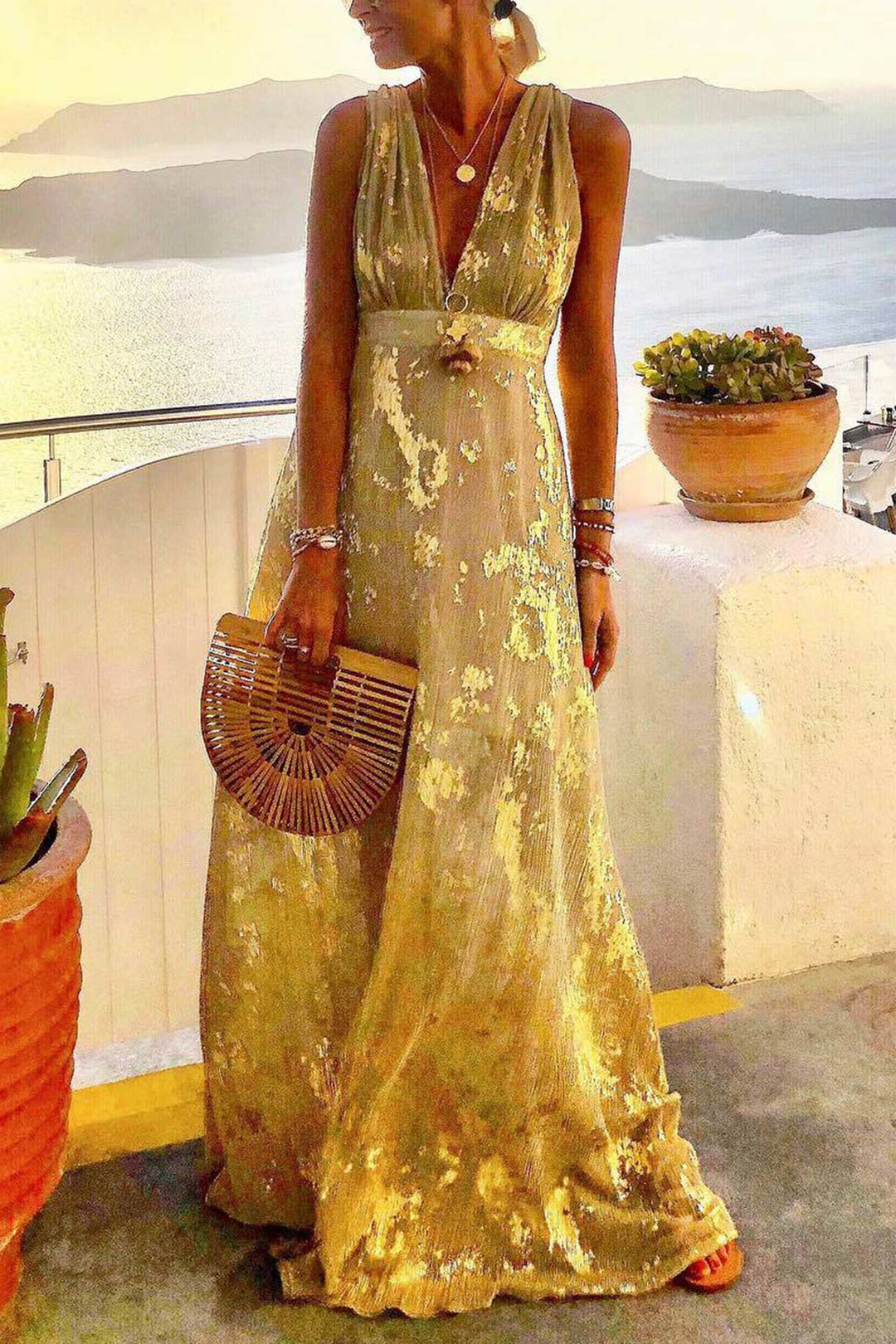 Stylish women's deep V-neck tank dress with golden star print. Sleeveless summer party or vacation wear.