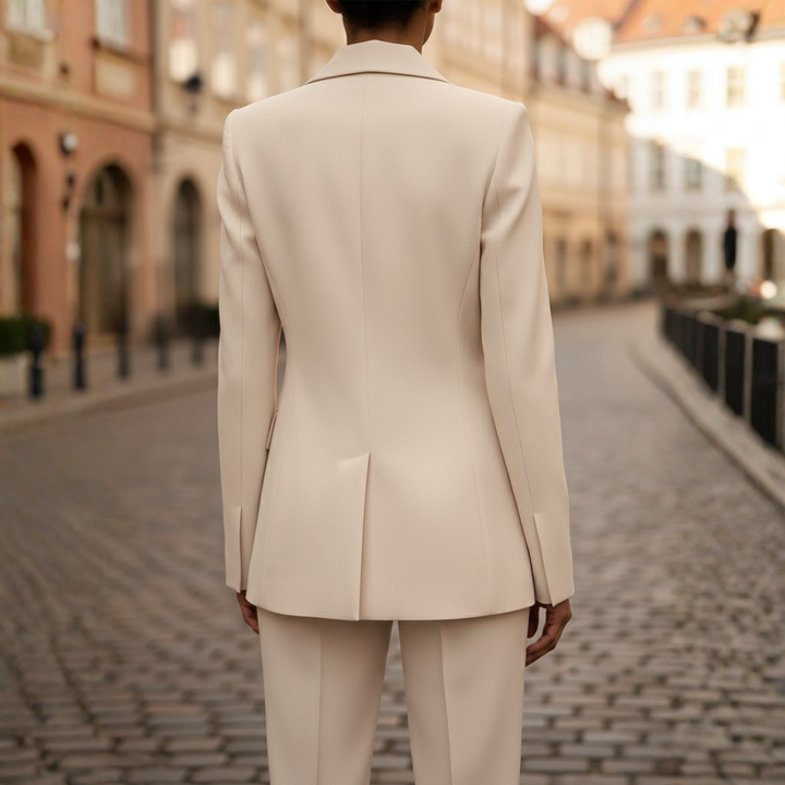 Elegant women's two-piece suit with tailored double-breasted blazer and classic straight leg pants.