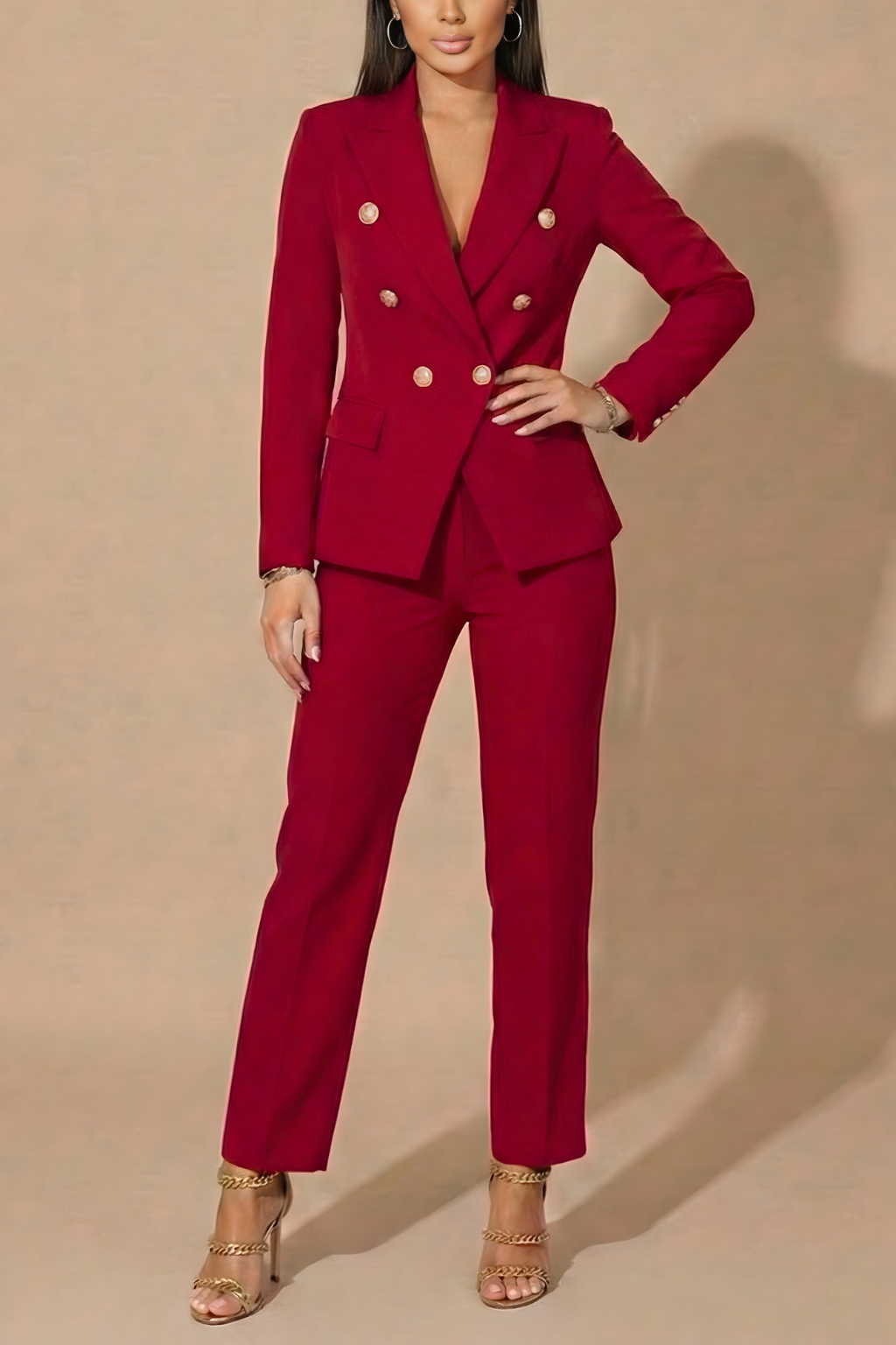 Professional woman modeling a chic double-breasted blazer and tailored trousers power suit for business events.