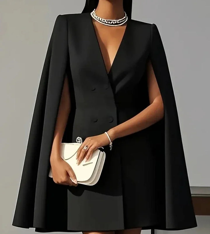 Stylish women's mini dress. A double-breasted design with elegant cape sleeves creates a sophisticated silhouette.
