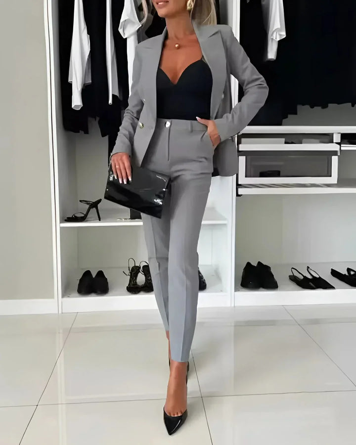 Styled women's professional workwear suit set with a tailored double-breasted blazer & matching trousers.