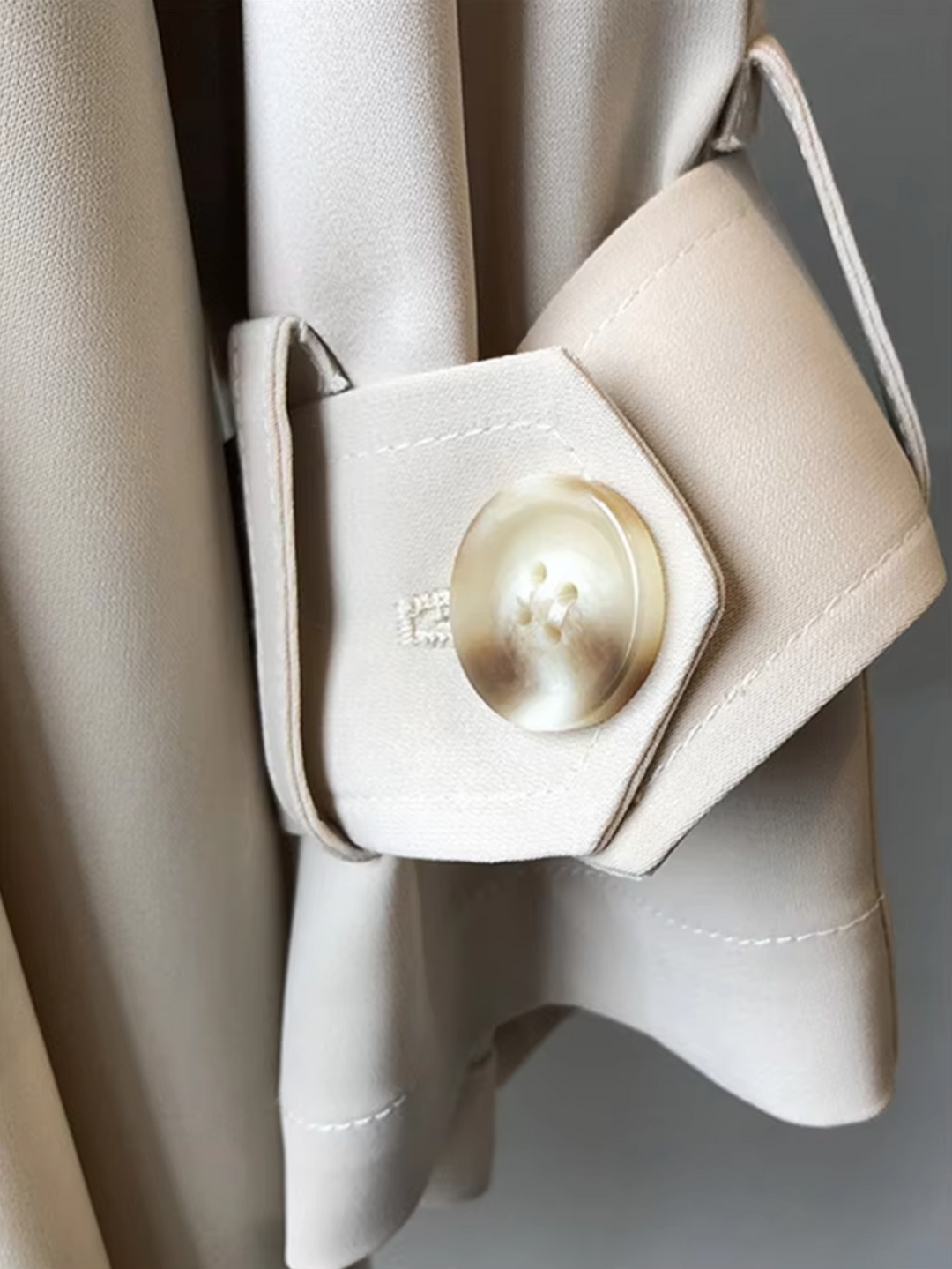 Elegant women's double-breasted trench coat with lapels; stylish, all-weather outerwear, perfect for business casual.