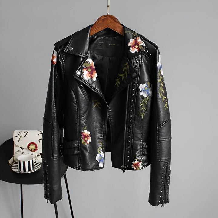 Women's edgy black jacket with intricate floral embroidery & silver studs, perfect for biker style.