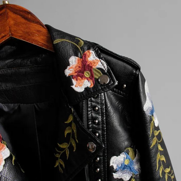 Fashionable women's outerwear: black studded & embroidered jacket with a unique floral design.