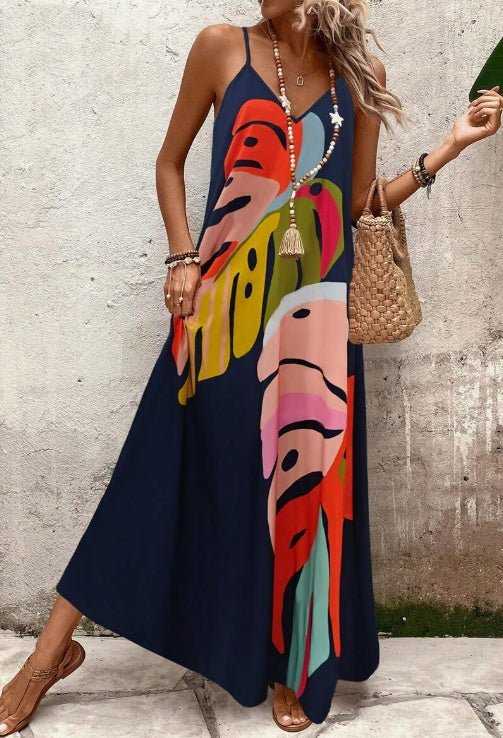 Abstract tropical print V-neck maxi sundress for women. Spaghetti strap, flowing design, ideal for summer vacation style.