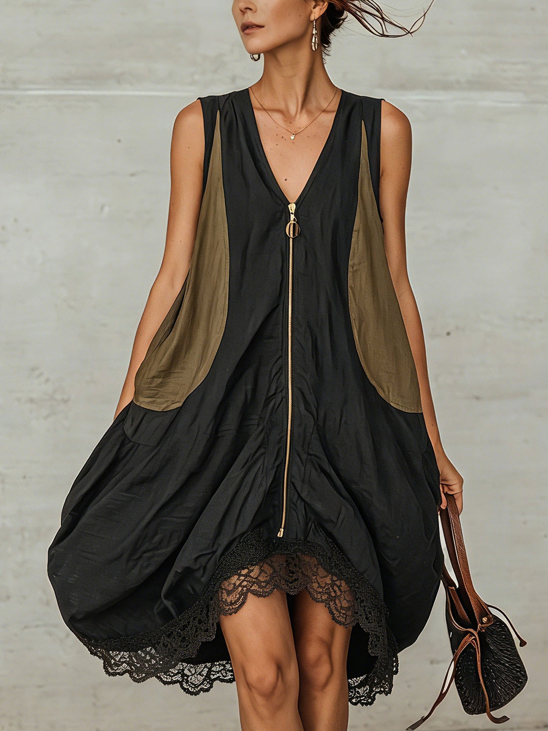 Women's effortless black midi dress with V-neck, sleeveless design, and delicate lace hem. Elegant and modern.
