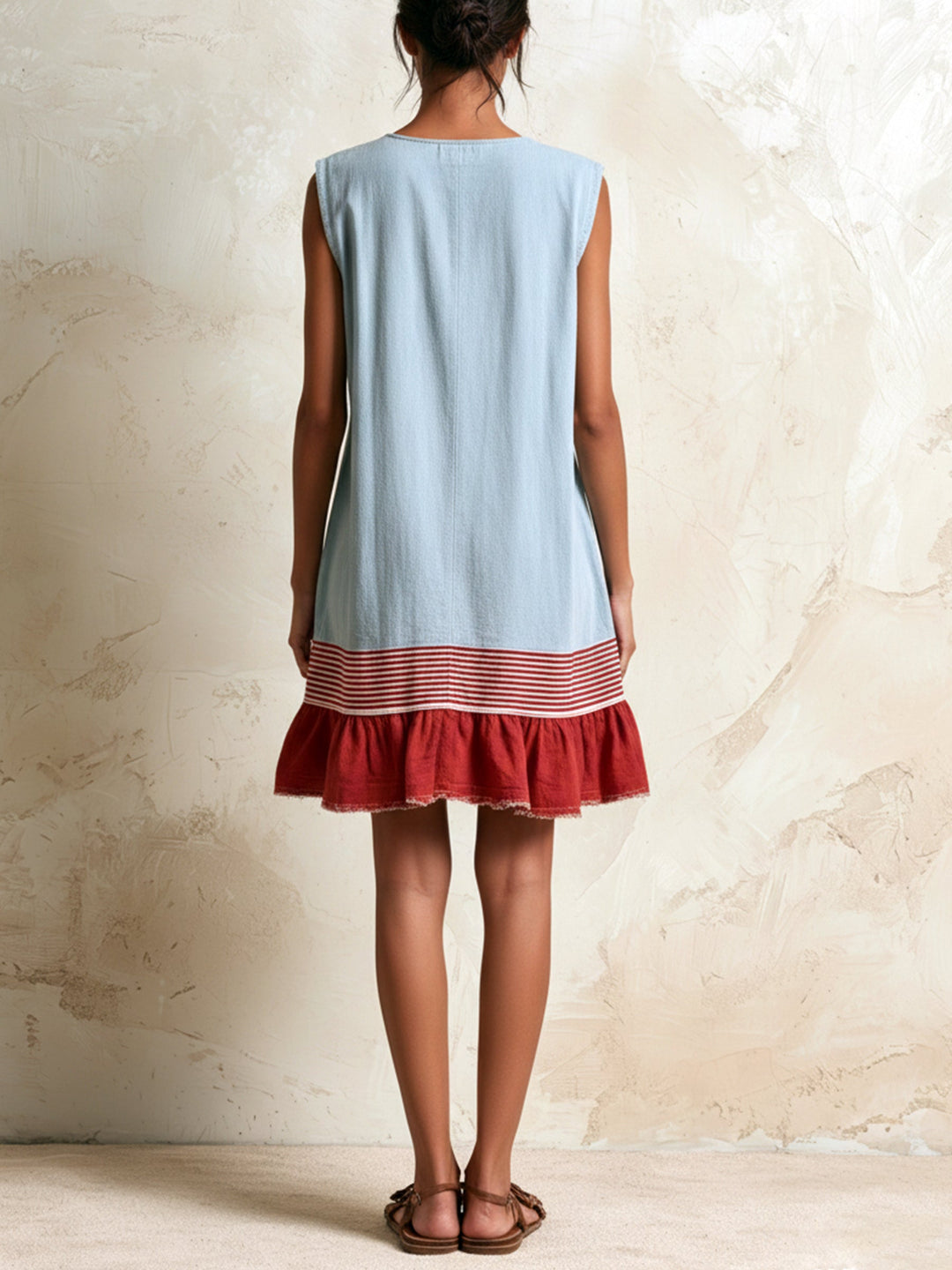 Sleeveless women's blue mini dress with a distinctive ruffle tiered contrast hem for a playful summer look.