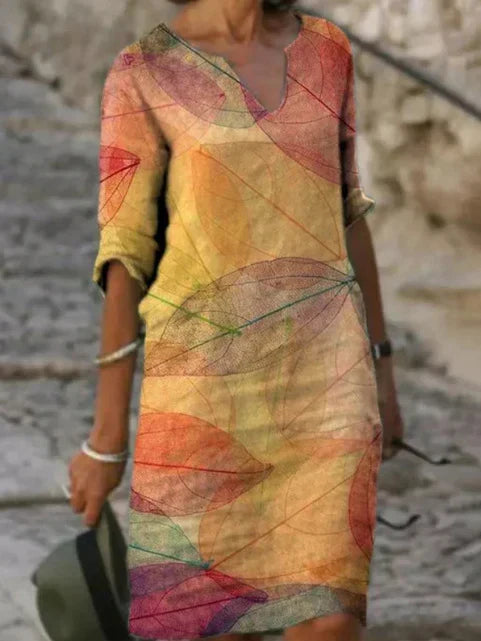 Stylish women's summer midi dress featuring a beautiful botanical print, V-neck, and relaxed silhouette for casual wear.