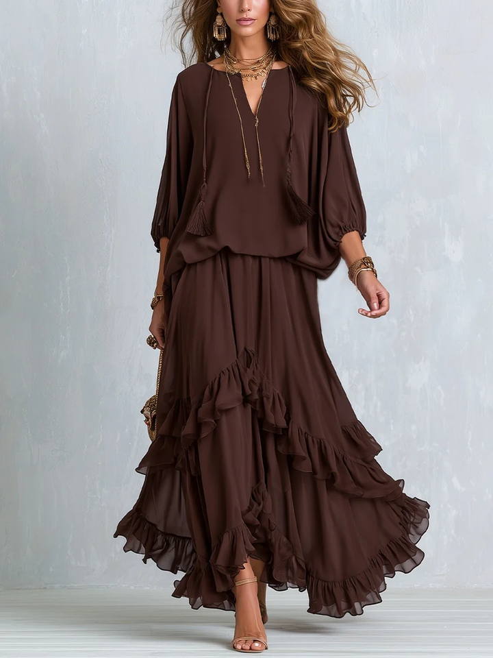Women's effortless brown wrap maxi dress with V-neck, long sleeves, and flowy tiered ruffle hem. Autumn fashion.