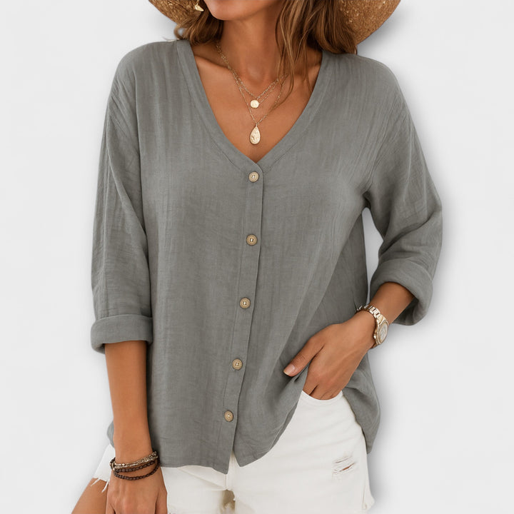 Soft v-neck, long sleeve women's button-up blouse in a relaxed fit for comfortable, chic everyday wear.