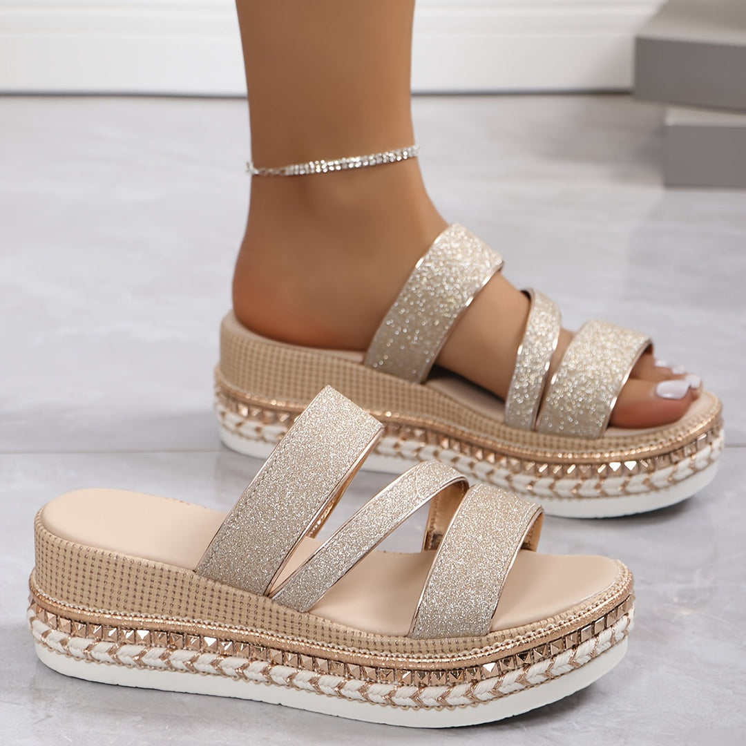 Slip-on women's flat sandals with open-toe design, offering all-day comfort. Perfect for casual summer wear.