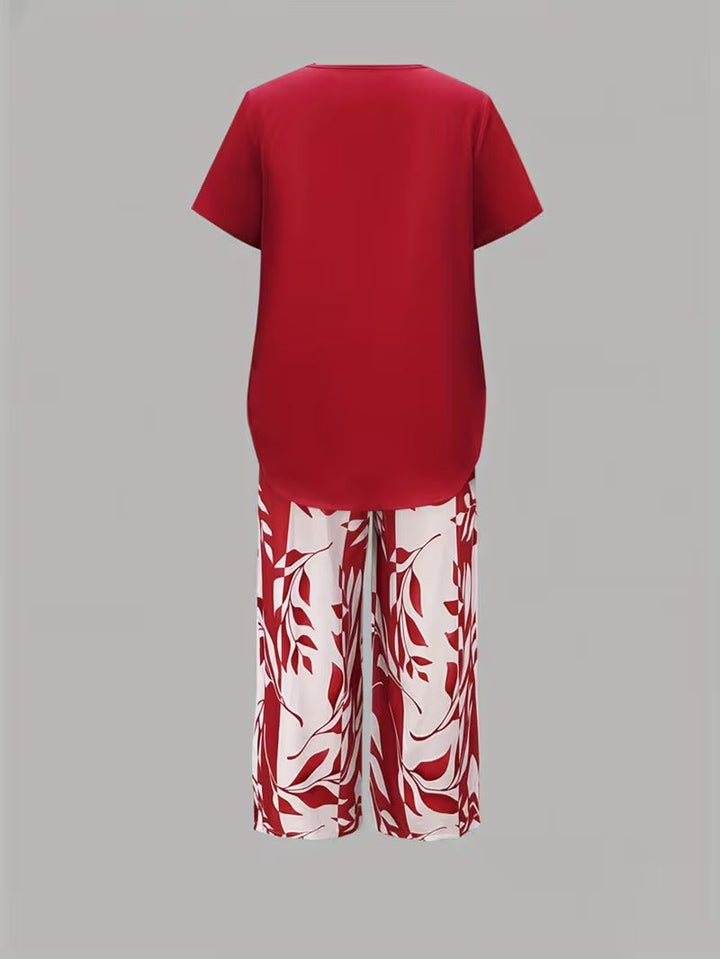 Chic women's leaf print two-piece set. Short sleeve top and cropped pants for a relaxed spring/summer look.