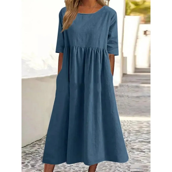 Flowing casual maxi dress for women featuring convenient pockets, half-sleeves, perfect for comfortable everyday style.