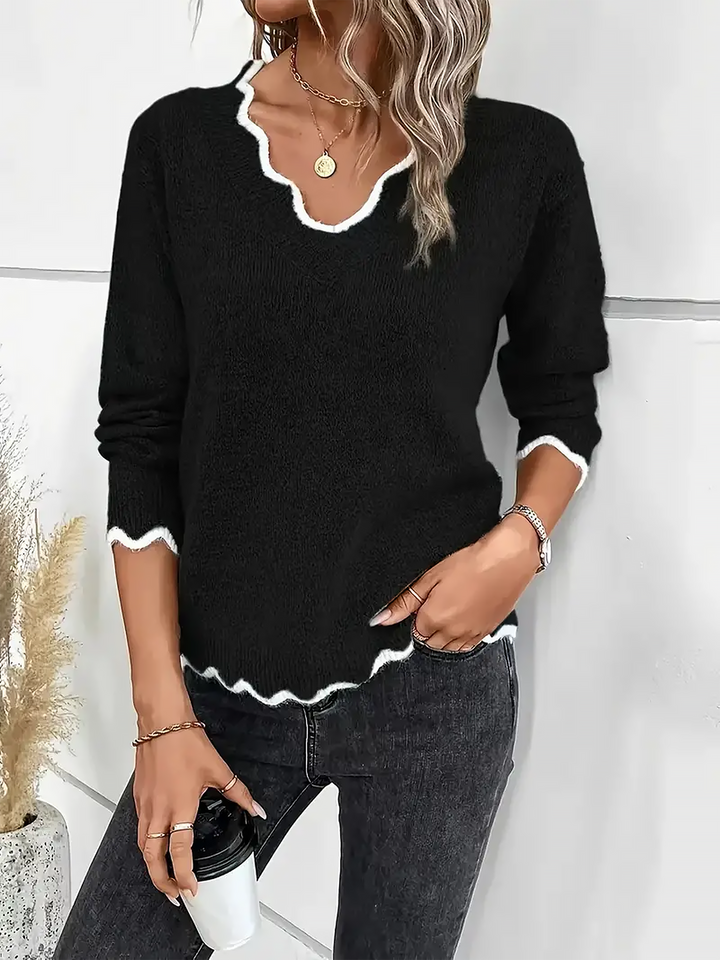Relaxed fit women's pullover, featuring a notch v-neck & long sleeves.