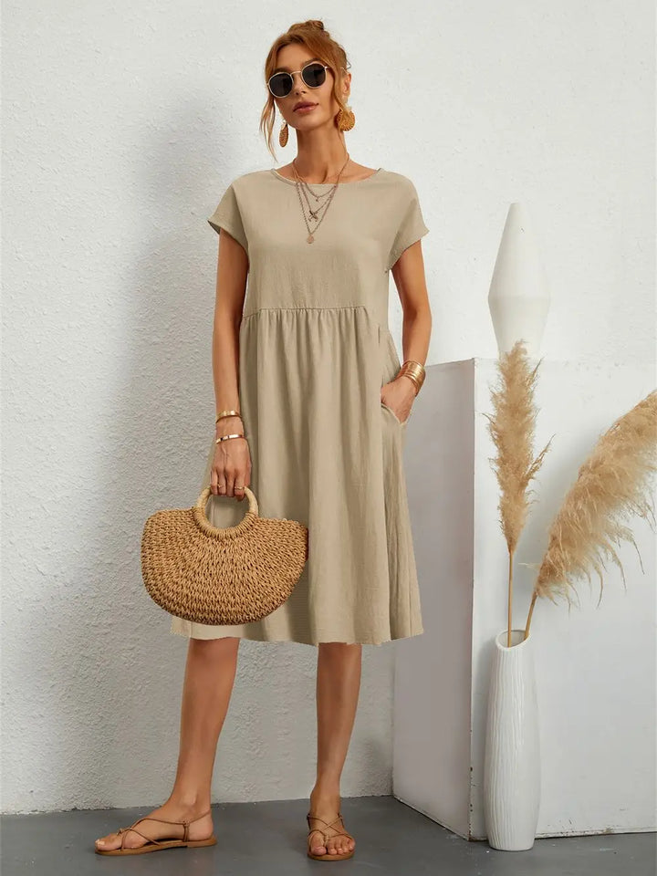 Spring fashion women's midi dress, a comfortable pocketed design for versatile day wear.