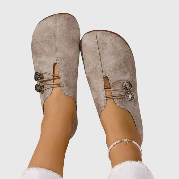 Stylish women's slip-on flats, versatile for everyday wear. Features toggle lace & comfortable barefoot feel.