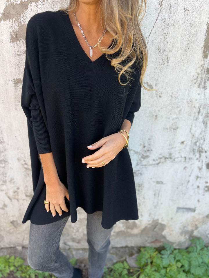 Women's effortless swing V-neck tunic sweater with batwing sleeves, relaxed fit for comfortable fall-winter wear.