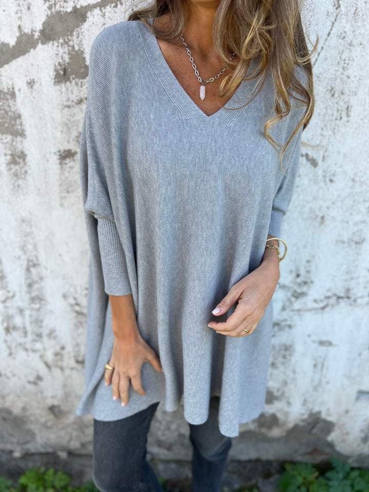 Relaxed fit women's V-neck swing sweater, a-line tunic style, perfect for comfortable daily wear in fall.