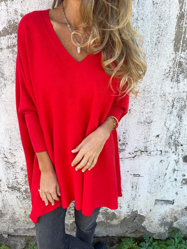Cozy women's oversized V-neck tunic sweater. Batwing sleeve, a-line fit, perfect for versatile casual styling.