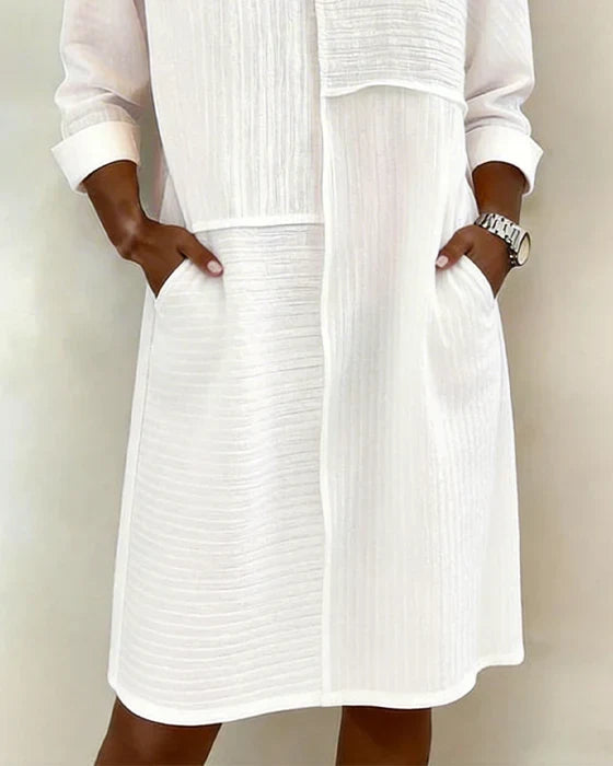 Relaxed fit women's shift dress, featuring textured fabric & three-quarter sleeves, great for spring outfits.