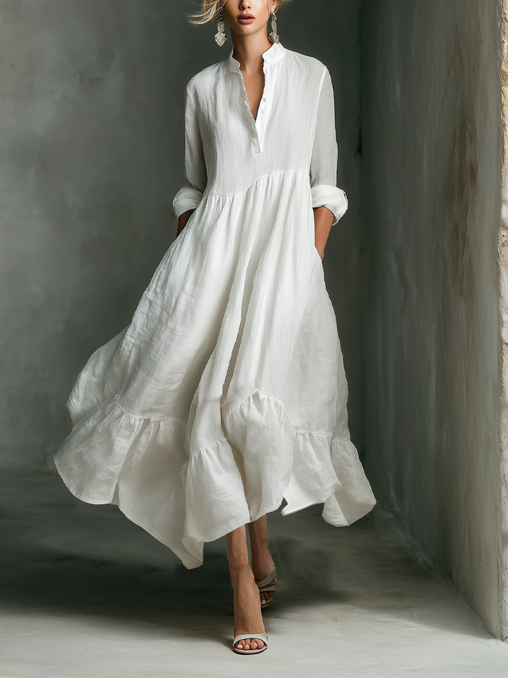 Women's Effortless White Maxi Dress with tiered skirt, long sleeves & stand collar. Perfect for casual summer resort wear.