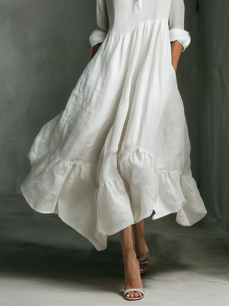 Women's white long sleeve tiered maxi dress, showcasing its elegant flowy design. A versatile casual summer and beach dress.