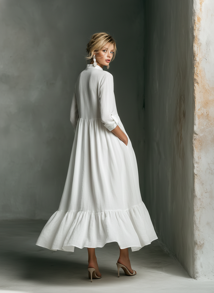 Casual women's white tiered maxi dress with long sleeves. Ideal for summer, beach vacations & resort wear, offering effortless style.