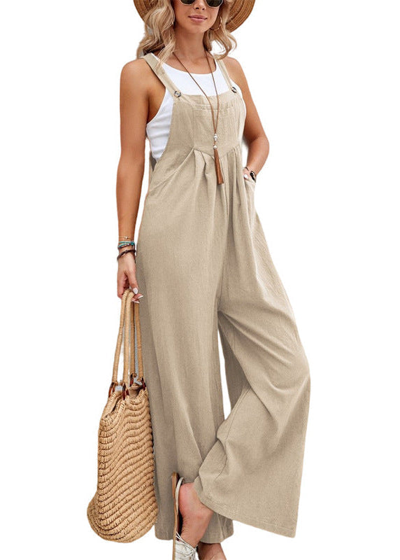 Model wearing a comfortable women's wide leg jumpsuit with adjustable straps & side pockets.