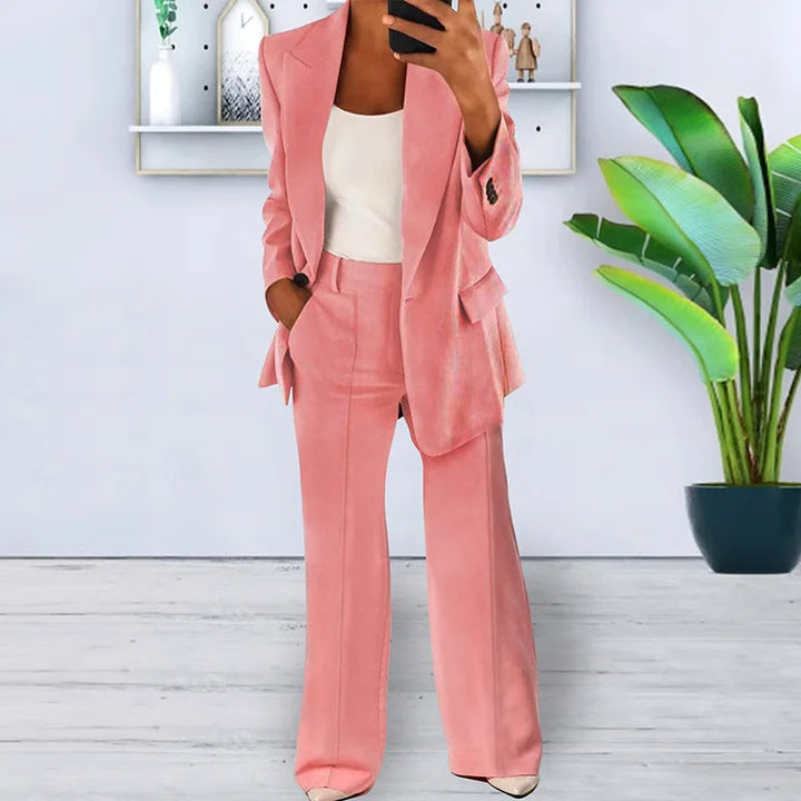 Stylish women's pantsuit featuring a tailored blazer & high-waisted wide-leg trousers for a modern work outfit.