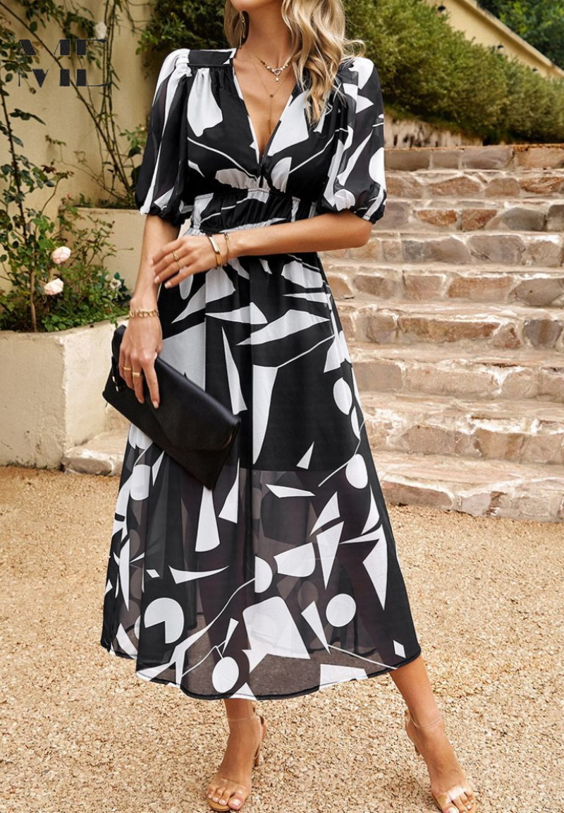 Model poses in women's elegant A-line floral midi dress with short sleeves, ideal for sunny days.
