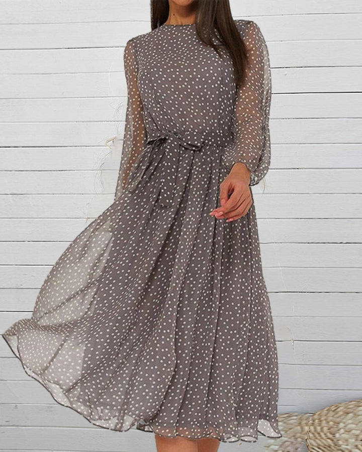 Comfortable women's knee-length A-line polka dot dress, featuring loose-fit design and elegant lantern sleeves.