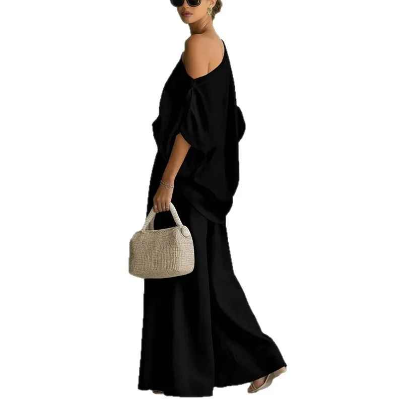 Back view: Women's tapered pants & asymmetric drape top, a sophisticated two-piece set for luxury resort or spring fashion.